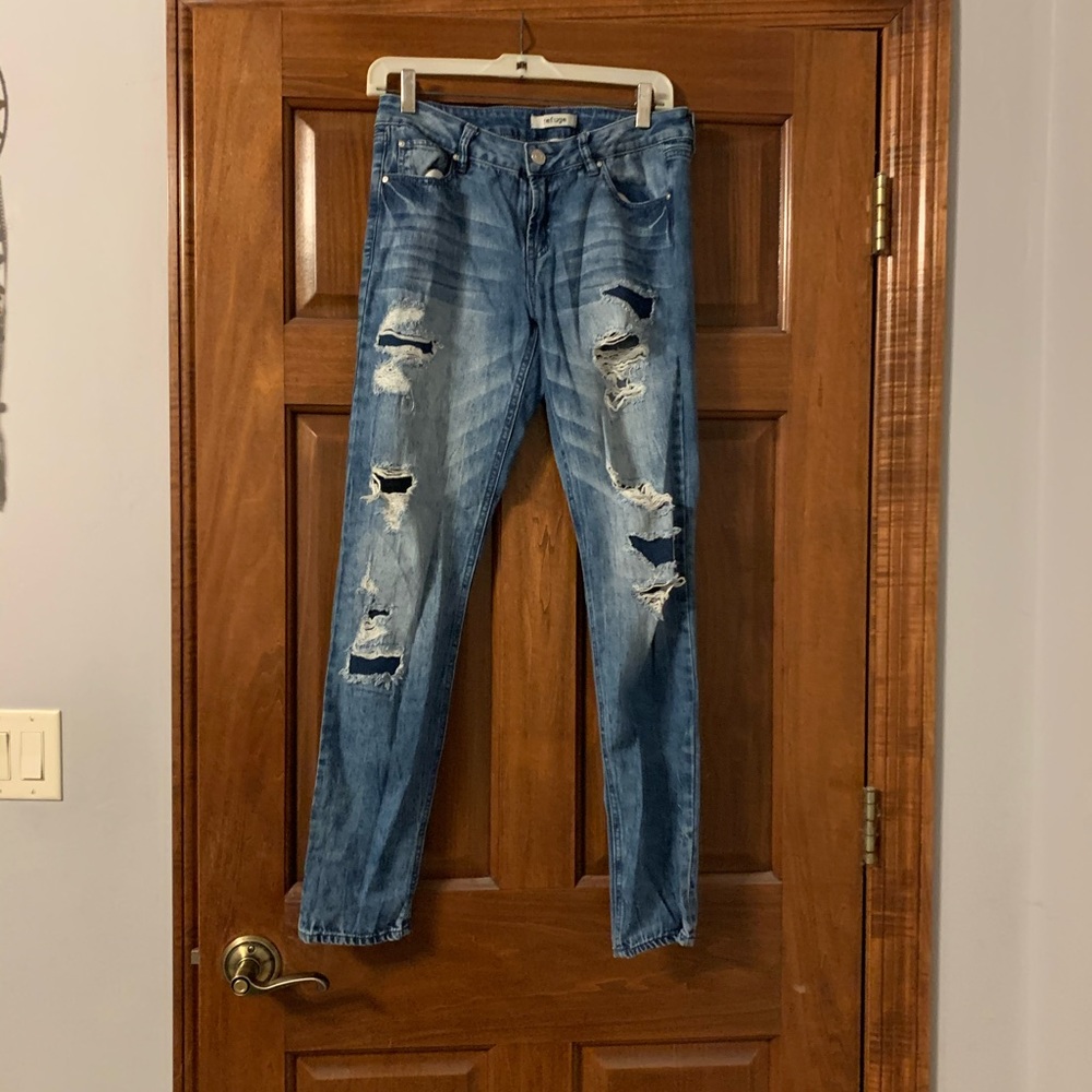 Distressed straight legged blue jeans
